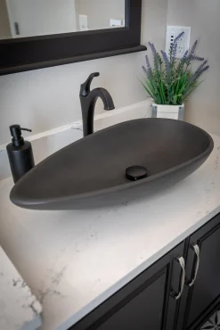 Pod Shaped Vessel Sink in Honed Lava Stone Above Counter / Vessel Sinks